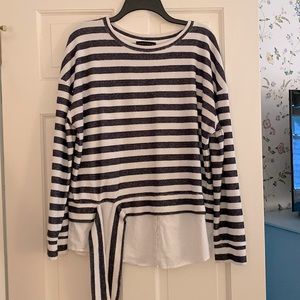 Long sleeve light weight pullover with built in blouse shirt tails.